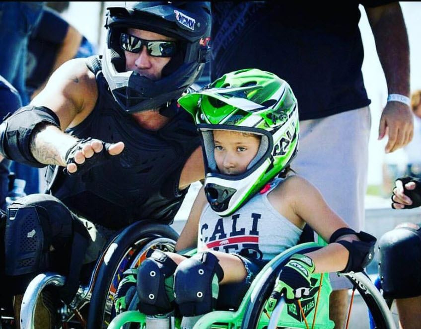 Jerry Diaz with a young rider at the skate park.