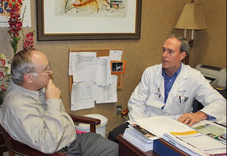 John Phillips discusses treatment options with his doctor.