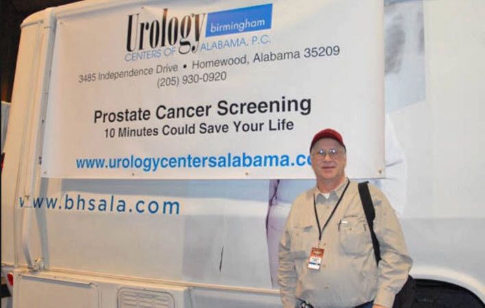 John Phillips beside Urology Centers of Alabama Van