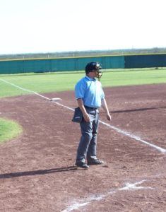 Baseball umpire standing on field