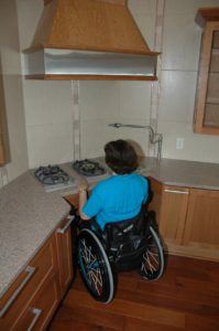 Rosemarie Rossetti demonstrates her accessible stove in her home, used as a model for universal design.