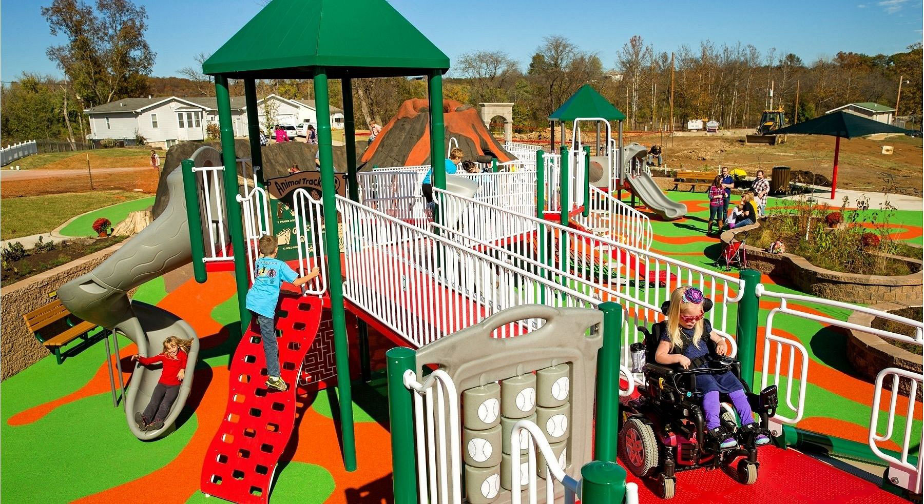 Children Playing On Playground In City Park Engaged In Football