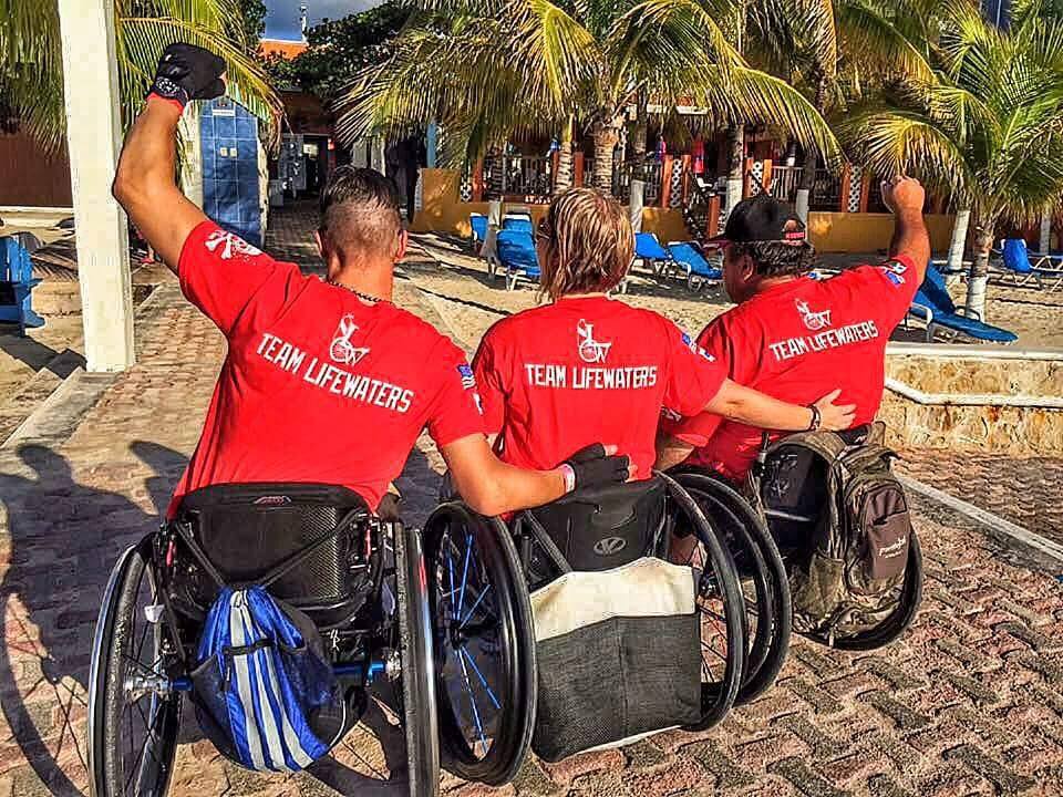 Three men in wheelchairs members of Team Lifewaters