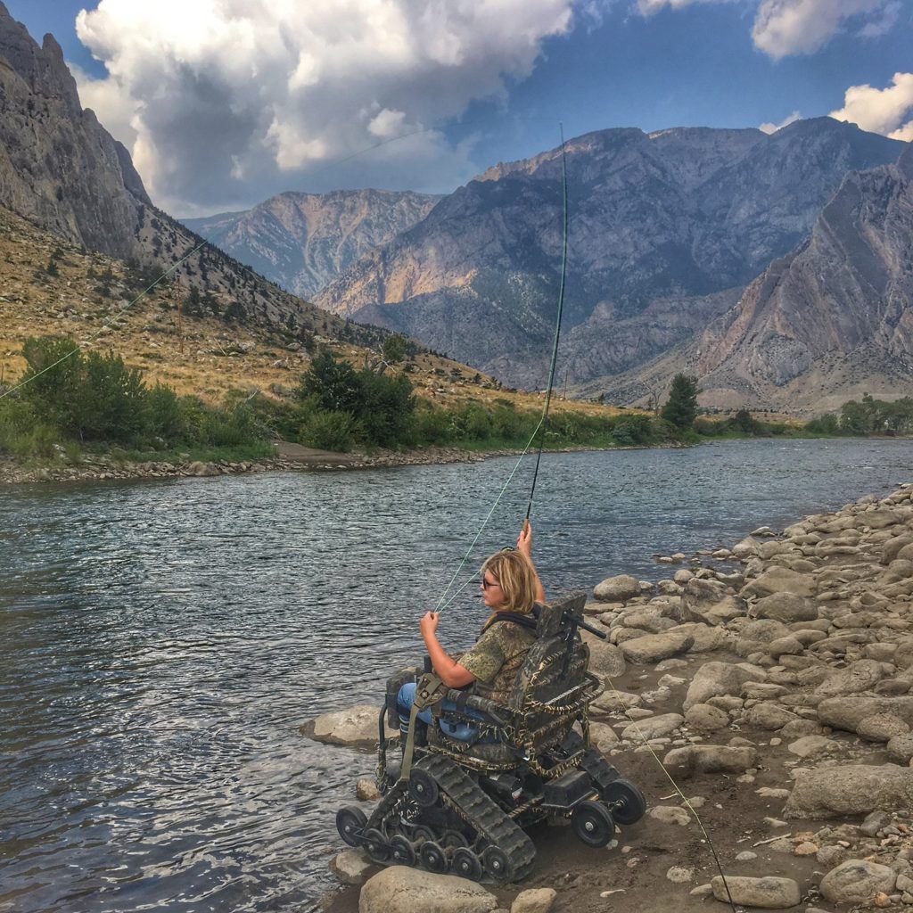 Ashlee Lundvall fly fishing from her Action Track Chair on the Clark's Fork River in Wyoming.