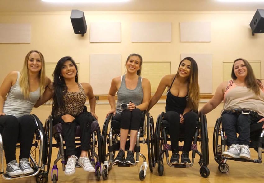 5 ladies in wheelchairs wearing workout clothing