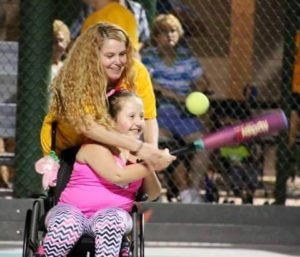 Young girl in wheelchair playing softball
