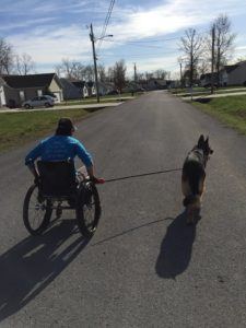Deborah Van Sickle takes a stroll with her service dog.
