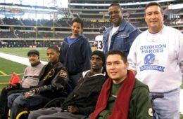 Chris and Eddie Canales with friends on football field