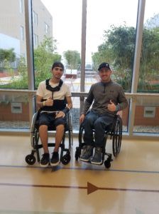 two men in wheelchairs smiling