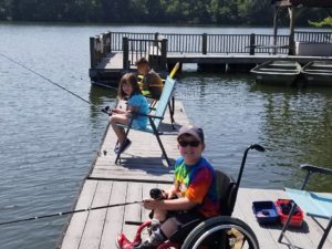 kid in wheelchair and friends fishing