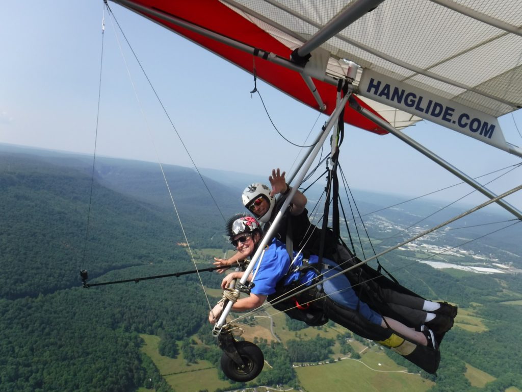 kim harrison is hang gliding with a spotter